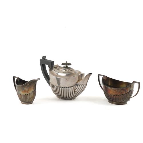 A SILVER COMPOSITE THREE PIECE TEA SET