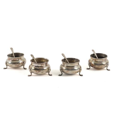 A SET OF FOUR SILVER SALTS AND FOUR ASSOCIATED SILVER SALT SPOONS