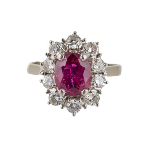 AN 18CT WHITE GOLD,  RUBY AND DIAMOND OVAL CLUSTER RING