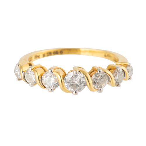 AN 18CT GOLD AND DIAMOND SEVEN STONE RING