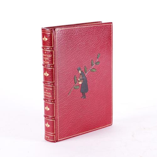 BINDING - Charles DICKENS (1812-70). A Christmas Carol, London, 1915, small 4to, 12 coloured plates by Arthur Rackham, FINELY BOUND by Bayntun in red morocco, the covers with figures of Scrooge in morocco onlays, slipcase. First Rackham trade edition.