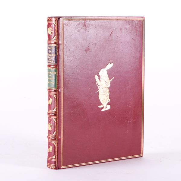 BINDING - "Lewis CARROLL" (1832-98). Alice's Adventures in Wonderland, London, 1974, 4to, 13 coloured plates by Arthur Rackham, FINELY BOUND in burgundy calf with the White Rabbit stamped in gilt on the upper cover. With another illustrated book. (2)