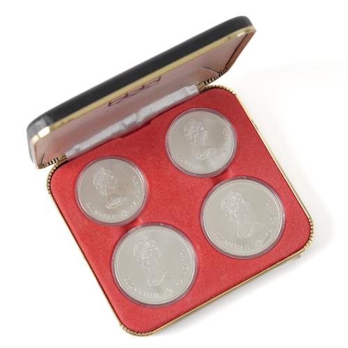 A SET OF FOUR CANADIAN SILVER COINS