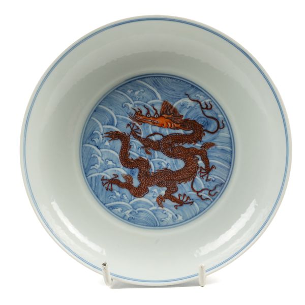 A CHINESE BLUE AND WHITE AND IRON-RED DRAGON DISH