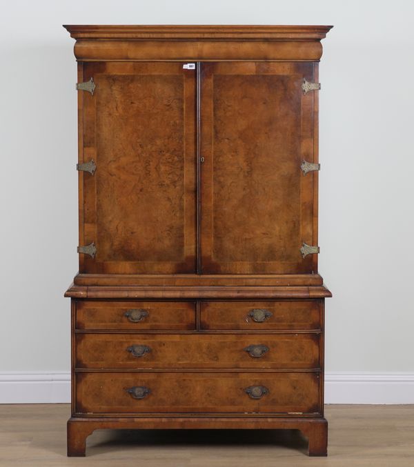 A GEORGE I STYLE FIGURED WALNUT TWO DOOR CABINET ON CHEST