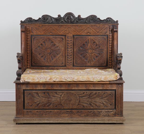 A VICTORIAN CARVED OAK BOX SEAT SETTLE