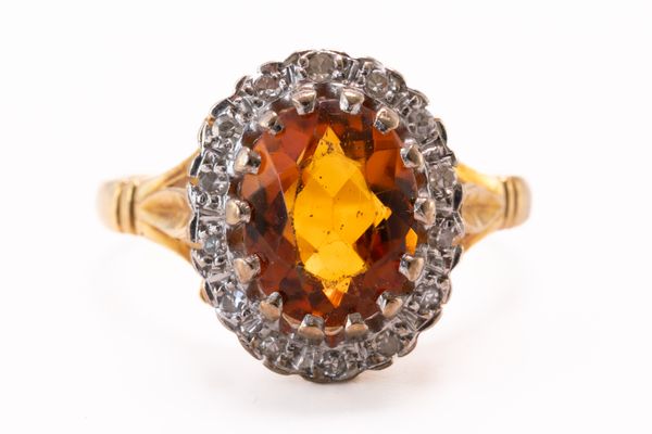 AN 18CT GOLD, CITRINE AND DIAMOND OVAL CLUSTER RING