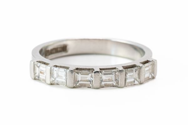 A PLATINUM AND DIAMOND SIX STONE HALF ETERNITY RING