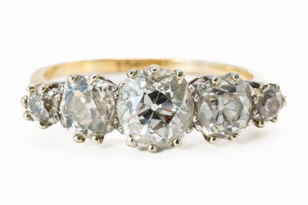 A GOLD AND DIAMOND FIVE STONE RING