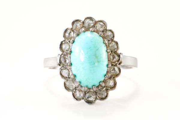 A TURQUOISE AND DIAMOND OVAL CLUSTER RING