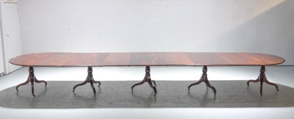 A GEORGE III MAHOGANY FIVE PILLAR EXTENDING DINING TABLE