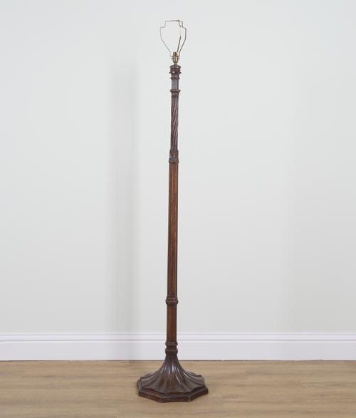 AN EARLY 20TH CENTURY CARVED OAK STANDARD LAMP