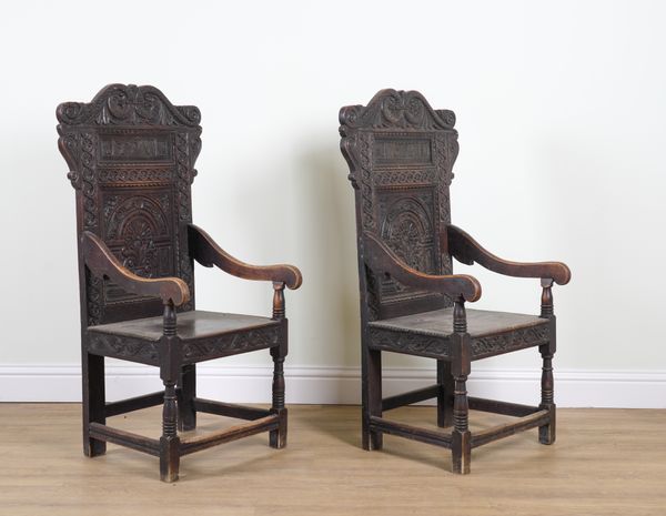 A NEAR PAIR OF 17TH CENTURY STYLE OAK WAINSCOT OPEN ARMCHAIRS (2)