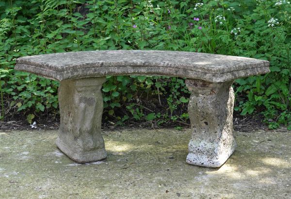 A RECONSTITUTED STONE CONCAVE GARDEN BENCH