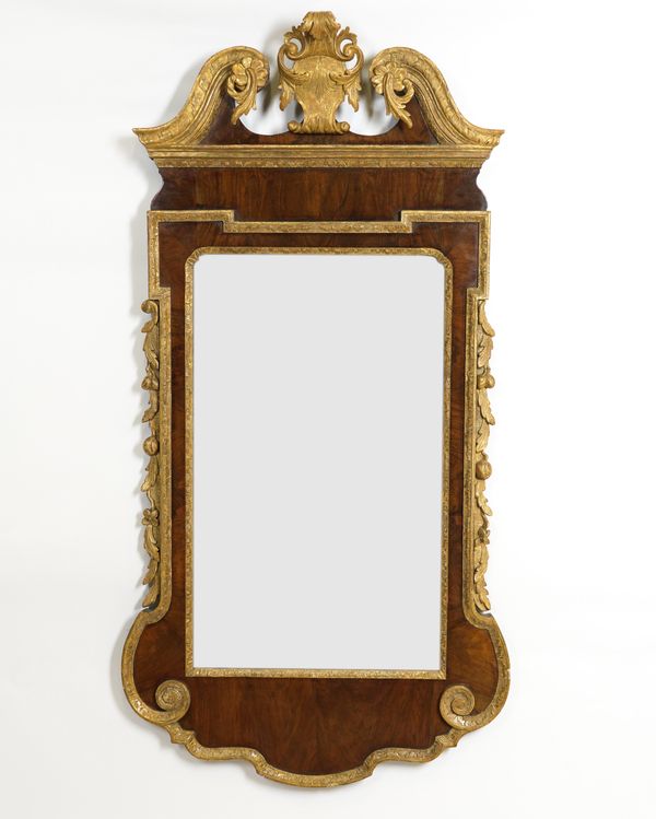 A GEORGE I STYLE WALNUT PARCEL GILT DECORATED PIER MIRROR