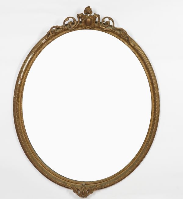 A VICTORIAN GILT FRAMED OVAL MIRROR