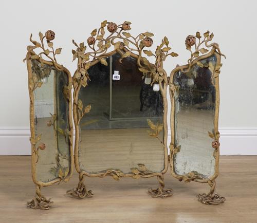 AN EARLY 20TH CENTURY POLYCHROME PAINTED FOLIATE MODELLED WROUGHT IRON TRIPTYCH DRESSING TABLE MIRROR