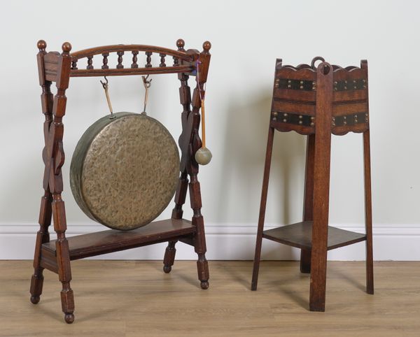 AN EARLY 20TH CENTURY OAK FRAMED DINNER GONG (2)