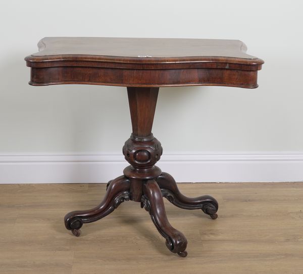 A VICTORIAN ROSEWOOD SERPENTINE FOLDOVER CARD TABLE