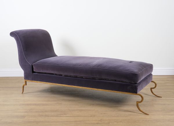 A PURPLE UPHOLSTERED CHAISE LONGUE