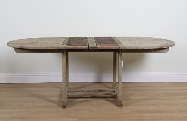 A TEAK OVAL EXTENDING GARDEN TABLE