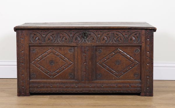 A 17TH CENTURY CARVED OAK TWIN PANEL COFFER