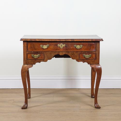 A GEORGE II FIGURED WALNUT LOW BOY