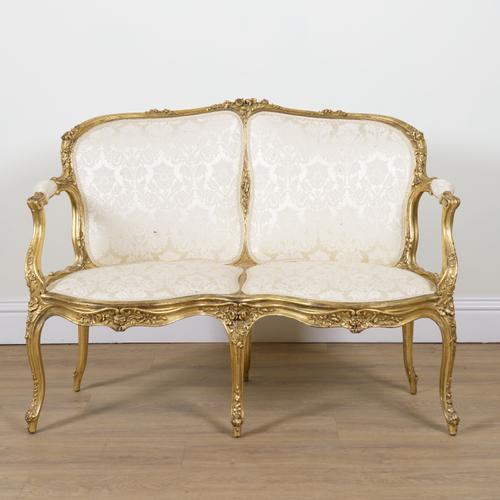 A ROCOCO REVIVAL GILT FRAMED TWO SEAT OPEN ARM SOFA