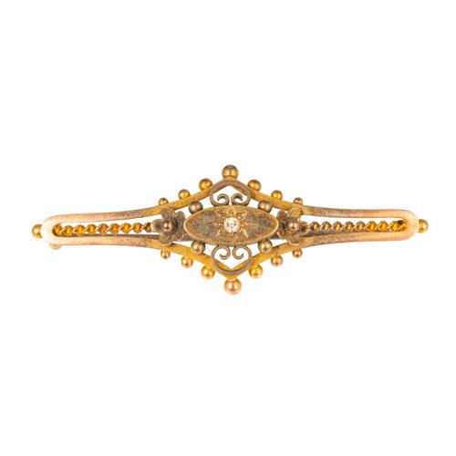 A GOLD AND DIAMOND SINGLE STONE BAR BROOCH