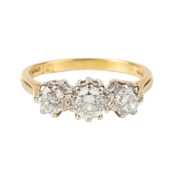 AN 18CT GOLD AND DIAMOND THREE STONE RING