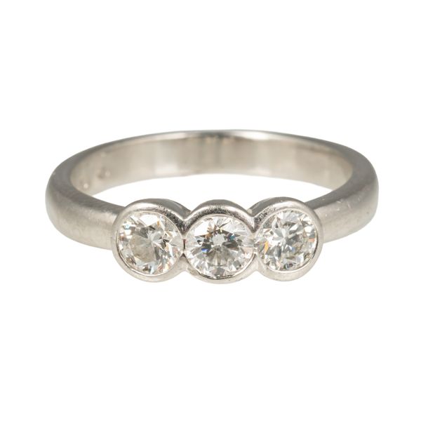A PLATINUM AND DIAMOND THREE STONE RING