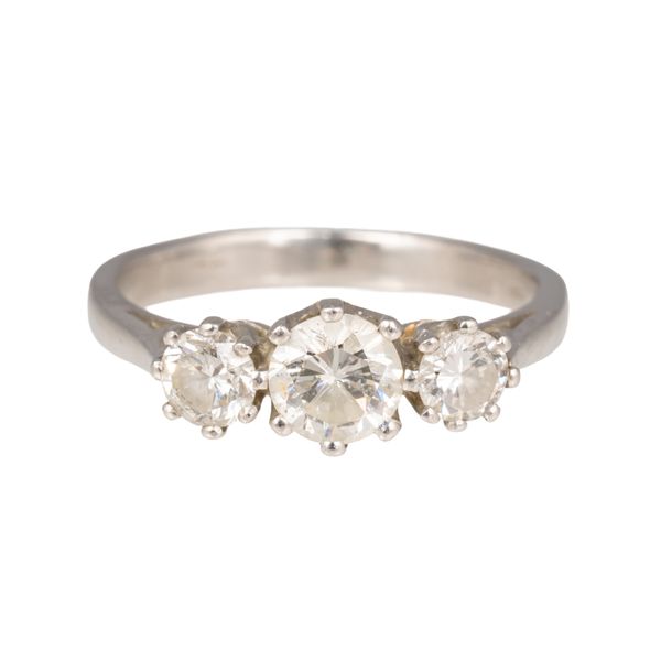 A PLATINUM AND DIAMOND THREE STONE RING