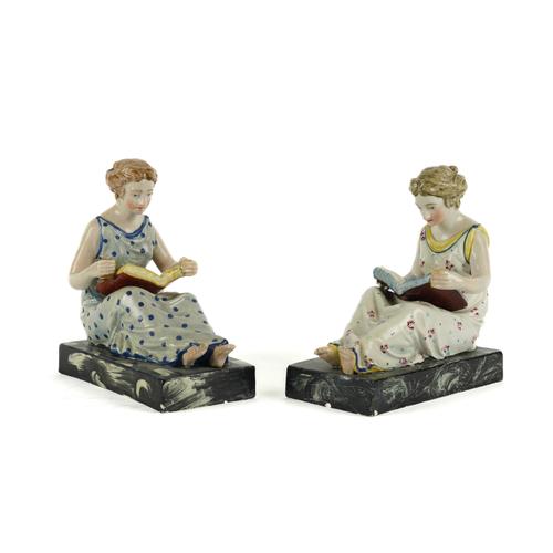 A PAIR OF STAFFORDSHIRE PEARLWARE FIGURES OF MAIDENS READING (2)
