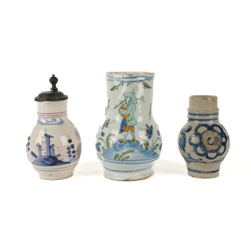 A SMALL WESTERWALD STONEWARE JUG AND TWO FAIENCE JUGS (3)