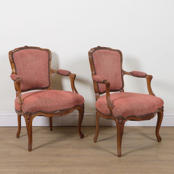 A PAIR OF LOUIS XV STYLE CARVED WALNUT FRAMED OEPN ARMCHAIRS (2)