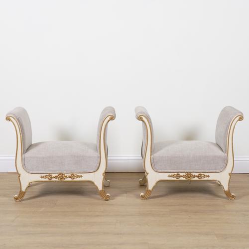 A PAIR OF ITALIAN WHITE PAINTED PARCEL GILT DECORATED WINDOW SEATS (2)