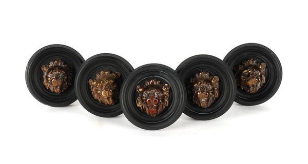 FIVE REGENCY STYLE BRASS MOUNTED BLACK PAINTED LION'S MASK CURTAIN TIE BACKS (5)