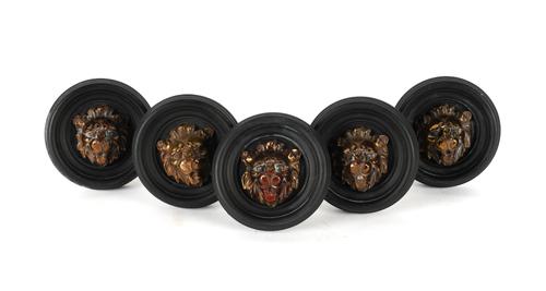 FIVE REGENCY STYLE BRASS MOUNTED BLACK PAINTED LION'S MASK CURTAIN TIE BACKS (5)