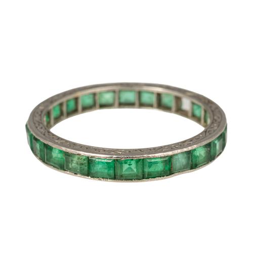 A PLATINUM AND EMERALD FULL ETERNITY RING