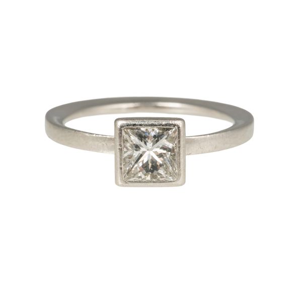 A PLATINUM AND PRINCESS CUT DIAMOND SOLITAIRE RING