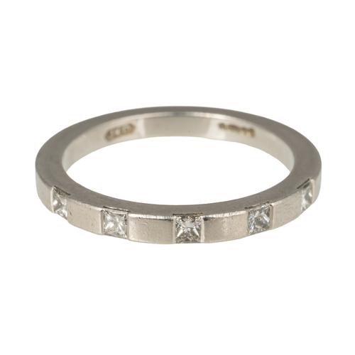 A PLATINUM AND DIAMOND FIVE STONE BAND RING
