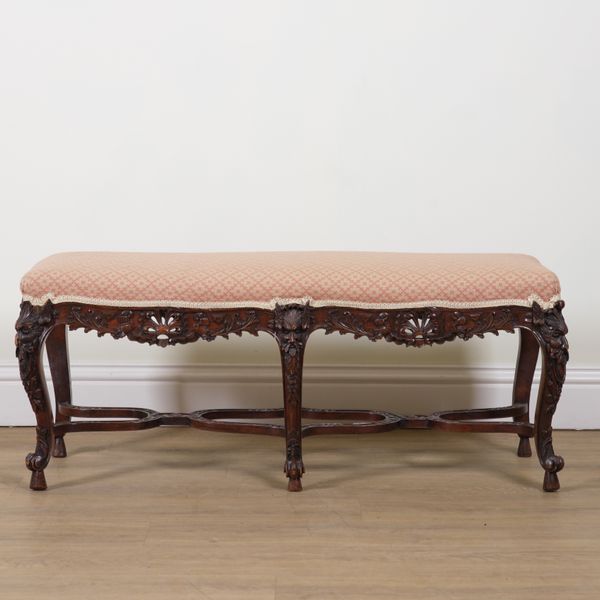 A LOUIS XV STYLE CARVED WALNUT FOOTSTOOL