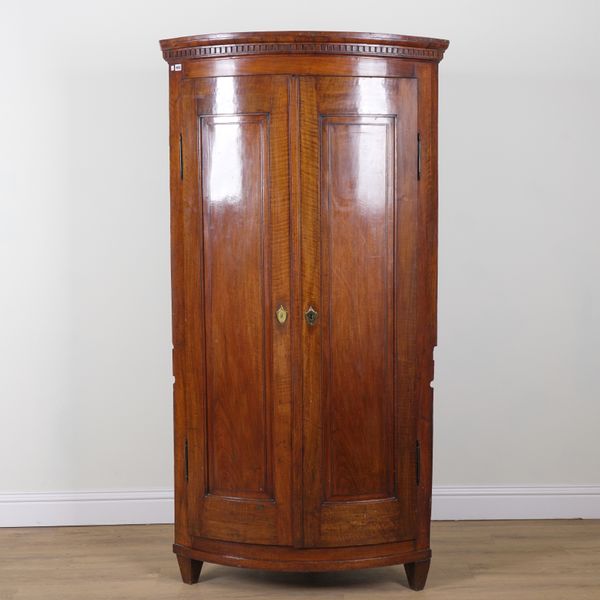 AN 18TH CENTURY CONTINENTAL MAHOGANY FLOORSTANDING BOWFRONT CORNER CABINET