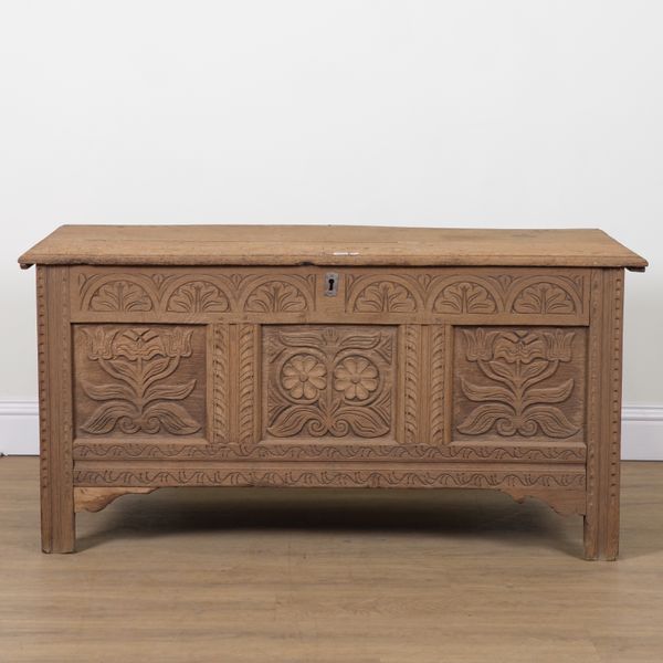 AN 18TH CENTURY AND LATER CARVED TRIPLE PANEL OAK COFFER