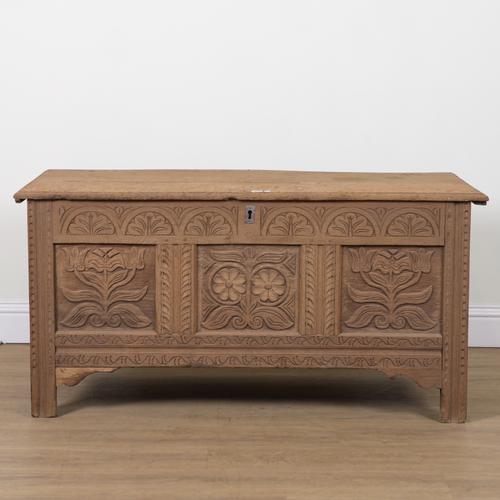 AN 18TH CENTURY AND LATER CARVED TRIPLE PANEL OAK COFFER