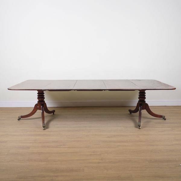 A GEORGE III MAHOGANY TWIN PEDESTAL EXTENDING DINING TABLE