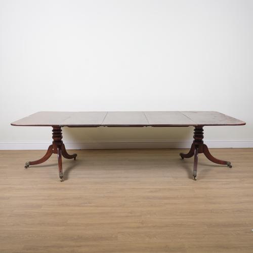A GEORGE III MAHOGANY TWIN PEDESTAL EXTENDING DINING TABLE