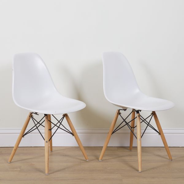 AFTER CHARLES & RAY EAMES; A PAIR OF RE DSW PLASTIC SIDE CHAIRS (2)