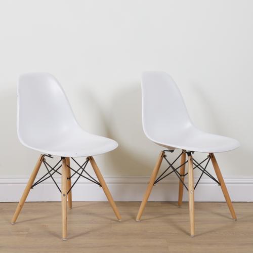 AFTER CHARLES & RAY EAMES; A PAIR OF RE DSW PLASTIC SIDE CHAIRS (2)