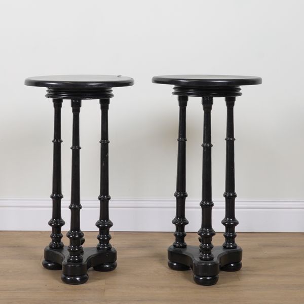 A PAIR OF EBONISED CIRCULAR OCCASIONAL TABLES (2)
